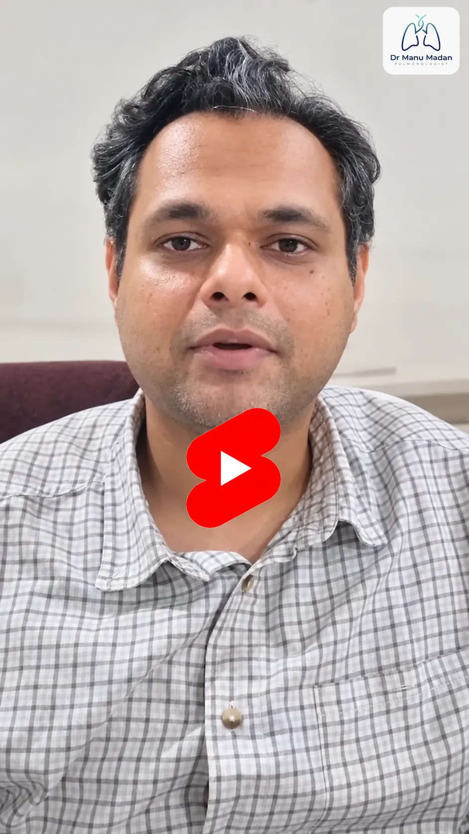 Dr Manu Madan - drmanumadan.com Video thumbnail: man in a checkered shirt speaking to camera, with Dr Manu Madan logo in the top-right corner and a red play button overlay