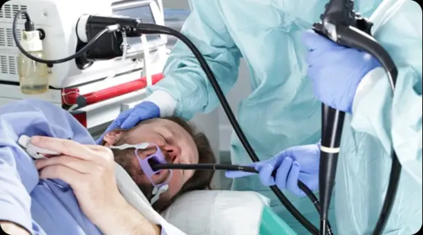 bronchoscopy - drmanumadan.com Anesthesia team intubating a patient with a laryngoscope and endotracheal tube in place on the operating table.